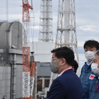 東京電力幹部から廃炉の状況について説明を受ける松野博一官房長官（左）＝福島第1原発で、2022年7月16日午前9時29分、代表撮影