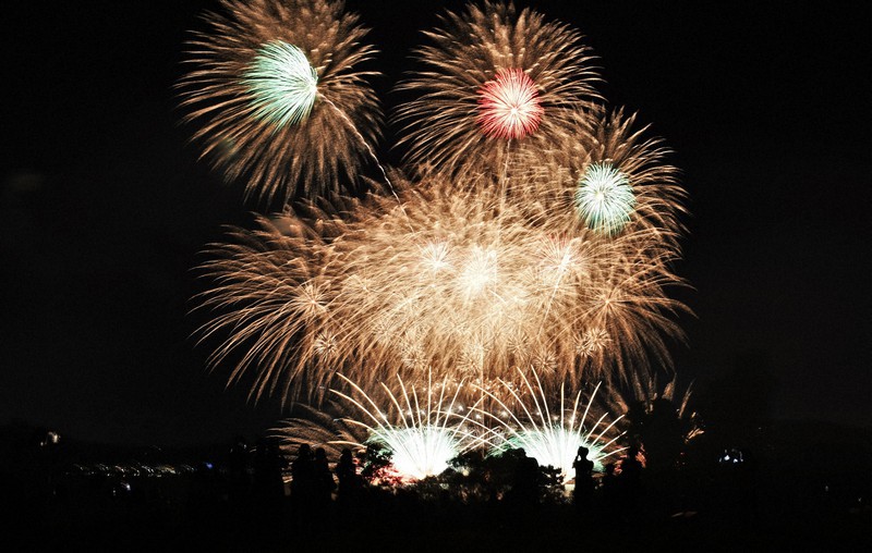 In Photos Giant 'torches,' fireworks light up night sky on shore of