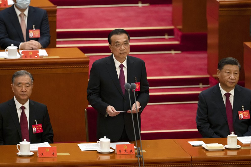 党大会の開幕式で発言する李克強首相(中央)。右は習近平総書記、左は汪洋氏=北京で2022年10月16日、AP