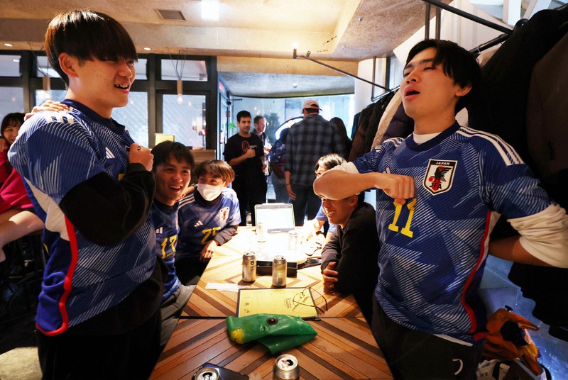サッカーW杯カタール大会の日本-クロアチア戦を前にバーで国歌を歌う男性客ら=東京都渋谷区で2022年12月5日午後11時56分、小出洋平撮影