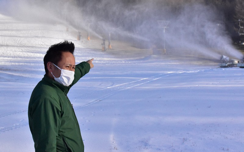 オープン前の丸沼高原スキー場で人工降雪機による降雪作業を見守る営業部部長代理の千明靖久さん=群馬県片品村で2022年12月2日午後3時2分、川地隆史撮影