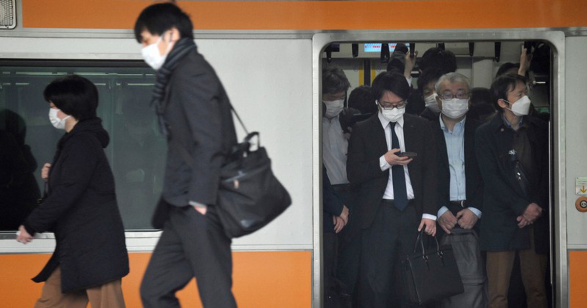 In Photos Most commuters in Tokyo still wearing masks on 1st day of eased rules The Mainichi