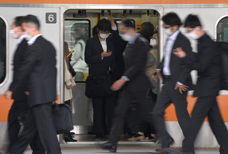 In Photos Most commuters in Tokyo still wearing masks on 1st day of eased rules The Mainichi