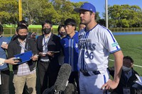 Yokohama BayStars Trevor Bauer is surrounded by reporters in Yokosuka, Kanagawa Prefecture, on  April 16, 2023. (AP Photo/Stephen Wade)