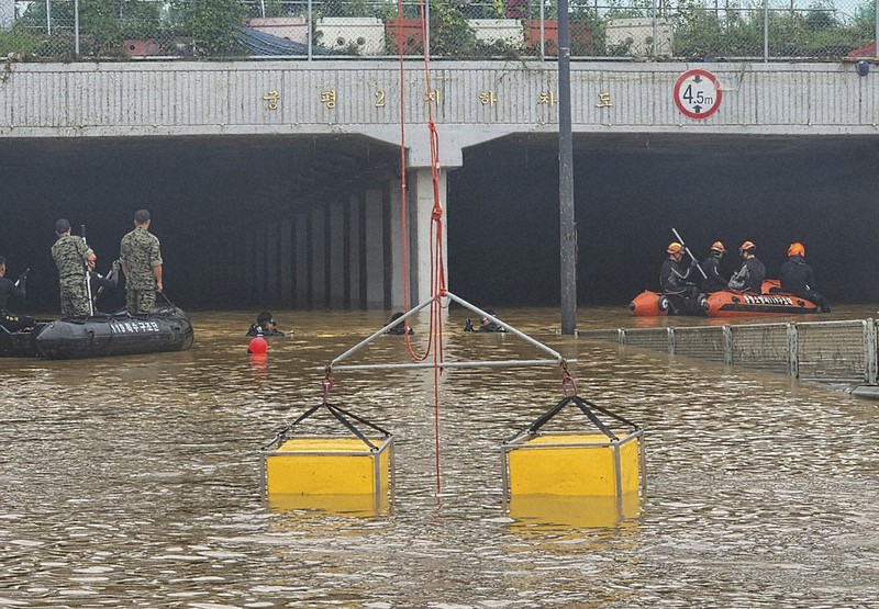 9 bodies pulled from a flooded road tunnel in South Korea as rains