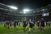 Members of the New Zealand team celebrate on the pitch after the end of the Rugby World Cup semifinal match between Argentina and New Zealand at the Stade de France in Saint-Denis, outside Paris, on Oct 20, 2023. New Zealand won the game 44-6 . (AP Photo/Christophe Ena)