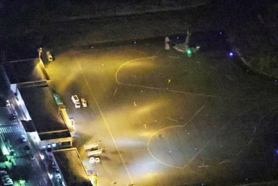 屋久島空港に駐機する墜落した米軍オスプレイの同型機（右上）＝鹿児島県屋久島町で2023年11月29日午後6時22分、本社ヘリから吉田航太撮影