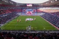 Flower wreaths surround a photograph of Bayern and Germany legend Franz Beckenbauer on the pitch of the Allianz Arena in Munich, Germany, on Jan. 19, 2024, before a memorial service. (AP)