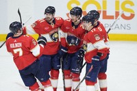 Florida Panthers center Eetu Luostarinen, center, is congratulated by teammates after he scored a goal during the second period of an NHL hockey game against the Colorado Avalanche on Feb. 10, 2024, in Sunrise, Fla. (AP Photo/Wilfredo Lee)