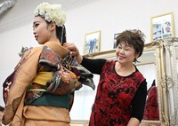 Beautician Eiko Nakahashi, right, looks at customer Maria Arakawa after dressing her up in a kimono for a celebration to mark turning 20, on Jan. 7, 2024, in Natori, Miyagi Prefecture. Nakahashi lost her house-cum-salon in the March 2011 tsunami, but resumed operation locally in 2019. (Mainichi/Kaho Kitayama)