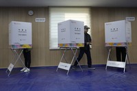 A voter exits out to cast his vote for the parliamentary election at a polling station in Seoul, South Korea, on April 10, 2024. (AP Photo/Ahn Young-joon)