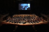 スクリーンには在りし日の坂本龍一の姿が映し出された＝東京都港区のサントリーホールで2024年3月31日、東北ユースオーケストラ提供