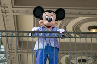 An actor dressed as Mickey Mouse greets visitors at the entrance to Magic Kingdom Park at Walt Disney World Resort, on April 18, 2022, in Lake Buena Vista, Fla. (AP Photo/Ted Shaffrey, File)