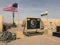 U.S. and Niger flags are raised side by side at the base camp for air forces and other personnel supporting the construction of Niger Air Base 201 in Agadez, Niger, on April 16, 2018. (AP Photo/Carley Petesch, File) 