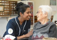 Kellapatha Withana Nimali Wathsala, left, a technical intern trainee from Sri Lanka who became a certified caregiver, speaks to a nursing facility user in the city of Nagasaki on April 10, 2024. (Mainichi/Arina Ogata)