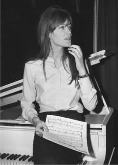 French singing star, Francoise Hardy, looks at a music score during a break in rehearsals, January 31, 1966, at the Savoy Hotel in London, England, where she is to appear for a three-week cabaret spot. (AP Photo, File)