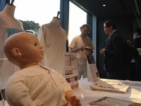 Garments made with organic cotton are displayed at the venue of a seminar on the apparel industry and environmental problems in Tokyo's Chiyoda Ward on June 5, 2024. (Mainichi/Yasuyoshi Tanaka)