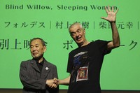 Novelist Haruki Murakami and film director Pierre Foldes shake hands at the end of a talk session after a screening of "Blind Willow, Sleeping Woman," an animated film adapted from the Japanese author's short stories, in Tokyo, June 15, 2024. (AP Photo/Mari Yamaguchi)