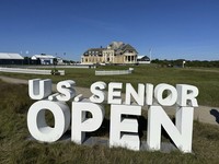 The clubhouse at the Newport Country Club is visible, on June 28, 2024, behind a sign for the U.S. Senior Open which is being played June 27-30 in Newport, R.I. (AP Photo/Jimmy Golen)