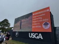 A sign warns fans to take shelter as severe weather forces a delay in the final round of the U.S. Senior Open golf tournament in Newport, R.I., on June 30, 2024. (AP Photo/Jimmy Golen)