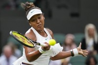 Naomi Osaka of Japan plays a forehand return to Emma Navarro of the United States during their match on day three at the Wimbledon tennis championships in London, on July 3, 2024. (AP Photo/Alberto Pezzali)