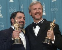 James Cameron, right, and Jon Landau hold the Oscars for Best Picture for the film "Titanic" at the 70th annual Academy Awards at the Shrine Auditorium in Los Angeles, March 23, 1998. (AP Photo/Reed Saxon, File)