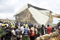 People and rescuers gather at the scene of a collapsed two-storey building in Jos, Nigeria on July, 12, 2024. (AP Photos)