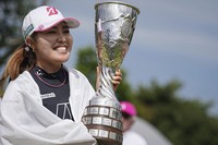 Ayaka Furue, of Japan, celebrates with her trophy after winning the Evian Championship women's golf tournament, in Evian, eastern France, on July 14, 2024. (AP Photo/Laurent Cipriani)