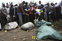 Sacks with human remains are seen after being removed from a quarry in Mukuru Kwa Njenga area in Nairobi, Kenya Saturday, July 13, 2024. Police in Kenya said Monday they have arrested the main suspect after nine dismembered bodies of women were found in a quarry in the capital, Nairobi. (AP Photo/Andrew Kasuku)