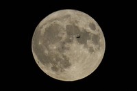 A plane passes in front of the moon, on Aug. 30, 2023, in Chicago. (AP Photo/Kiichiro Sato, file)