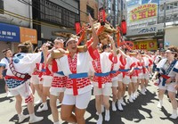 Women carrying a portable shrine on their shoulders parade through the Tenjinbashisuji shopping arcade in Osaka's Kita Ward during the "Gal Mikoshi" event on July 23, 2024. (Mainichi/Takashi Murata)