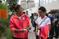 Naomi Osaka, of Japan, left, talks to a journalist after her practice session at the 2024 Summer Olympics, on July 25, 2024, in Paris, France. (AP Photo/Andy Wong)