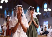 People offer prayers during an early morning Mass at Urakami Cathedral in Nagasaki on Aug. 9, 2024. (Mainichi/Kenji Ikai)