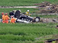 Investigators are seen searching for a missing police officer in the city of Shinjo, Yamagata Prefecture, on July 26, 2024. The plaintiffs in a group lawsuit over climate change include one or more people from Yamagata Prefecture, where torrential rains have fallen this summer. (Mainichi/Kan Takeuchi)
