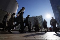  Commuters walk in a passageway during rush hour at Shinagawa Station on Feb. 14, 2024, in Tokyo. (AP Photo/Eugene Hoshiko, File)