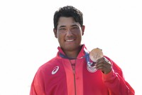 Hideki Matsuyama, of Japan, poses with his bronze medal following the medal ceremony for the men's golf at the 2024 Summer Olympics, on Aug. 4, 2024, at Le Golf National in Saint-Quentin-en-Yvelines, France. (AP Photo/Matt York) 