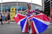 Fans of singer Taylor Swift, called Swifties, arrive at Wembley Stadium in London, on Aug. 15, 2024 for the first of five concerts of Taylor Swift's Eras Tour. (AP Photo/Alastair Grant)