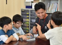 Darlami Manoj, second from right, plays with children at an after-school child care center in Tosu, Saga Prefecture, on Aug. 19, 2024. (Mainichi/Takeshi Sato)