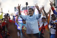 Venezuelan President Nicolas Maduro flashes victory hand signs at supporters during a pro-government rally, in Caracas, Venezuela, on Aug. 17, 2024. (AP Photo/Cristian Hernandez )