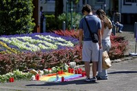 People lay flowers near the scene of a knife attack in Solingen city center, Germany, on Aug. 24, 2024, after three people were killed and at least eight people were wounded Friday night at the festival. (Henning Kaiser/dpa via AP)