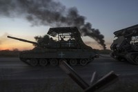 Ukrainian servicemen ride atop a tank after returning from Russia, near the Russian-Ukrainian border in the Sumy region, Aug. 17, 2024. (AP Photo/Evgeniy Maloletka)