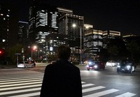 This unrelated file photo shows a man standing in Tokyo's Chiyoda Ward at night. (Mainichi/Natsuki Nishi)