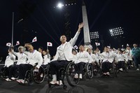 Members of the Japanese delegation parade during the Opening Ceremony for the 2024 Paralympics, on Aug. 28, 2024, on Concorde plaza in Paris, France. (AP Photo/Christophe Ena)