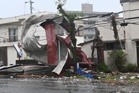 Metal sheeting apparently from a building roof is seen tangled around power lines in the city of Miyazaki on Aug. 29, 2024. (Mainichi/Kazuhito Shimozono)