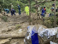 Rescue workers clear mud and debris brought down by a flood in Lang Nu hamlet in Lao Cai province, Vietnam, on Sep. 10, 2024. (Pham Hong Ninh/VNA via AP)