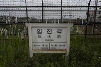 A directional sign showing the distance to North Korea's Kaesong and Seoul stands in front of fences adorned with ribbons bearing messages wishing for the reunification of the two Koreas at the Imjingak Pavilion in Paju, South Korea, on May 25, 2024. (AP Photo/Jae C. Hong)
