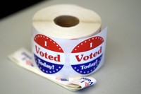 A spool of stickers rests on a table at a polling station during Massachusetts state primary voting, on Sept. 3, 2024, in Newton, Mass. (AP Photo/Steven Senne, File)