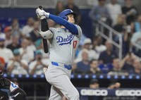 Los Angeles Dodgers' Shohei Ohtani (17) hits a two-run home run during the third inning of a baseball game against the Miami Marlins, on Sept. 17, 2024, in Miami. (AP Photo/Marta Lavandier)