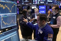 Specialist Genaro Saporito, foreground, works with traders at his post on the floor of the New York Stock Exchange, on Sept. 18, 2024. (AP Photo/Richard Drew)