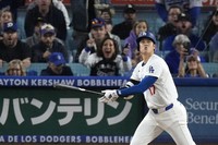 Los Angeles Dodgers' Shohei Ohtani heads to first after hitting a two-run home run during the fifth inning of a baseball game against the Colorado Rockies, on Sept. 20, 2024, in Los Angeles. (AP Photo/Mark J. Terrill)